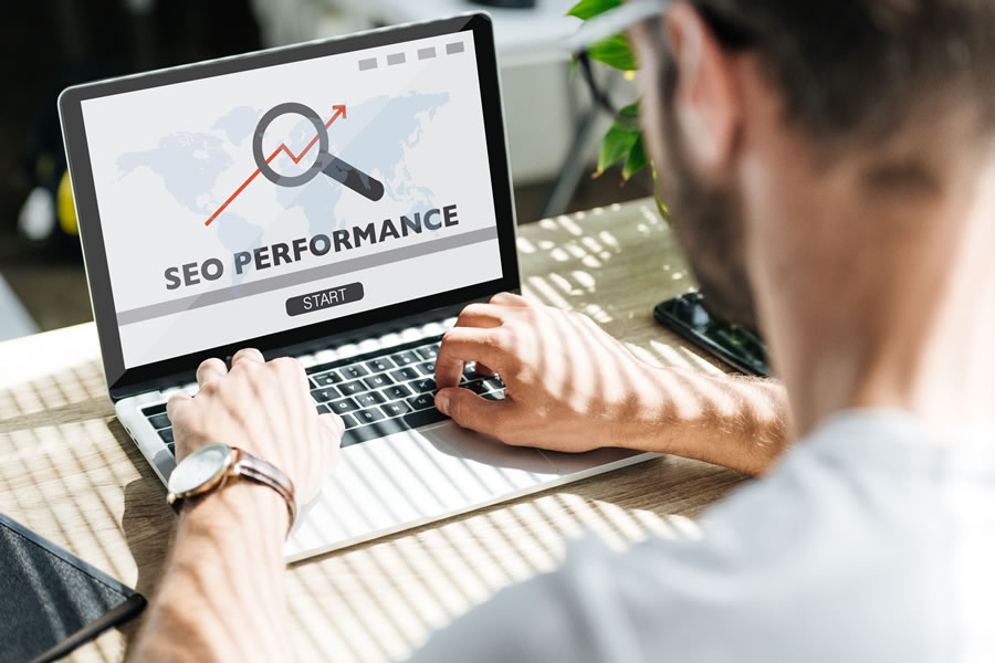 Profissional analisando gráficos de desempenho digital em ambiente de trabalho